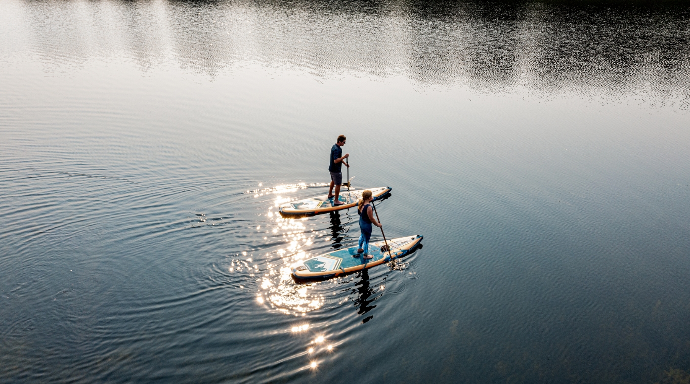 Couple kayaking on a lake near Wilderness Club, Montana